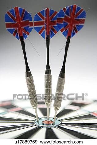 Darts in bull's eye of dart board, close-up (focus on dart) View Large Photo Image Stock Photo - Darts in bull's eye of dart board, close-up (focus on dart). Fotosearch