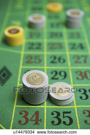 Gambling chips and poker on betting mat View Large Photo Image Picture - Gambling chips and poker on betting mat. Fotosearch