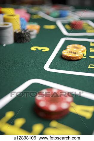 Stock Photograph - Gambling chips on betting mat. Fotosearch