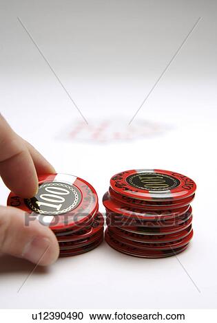 Stock Image - Man holding stack of Gambling Chips. Fotosearch