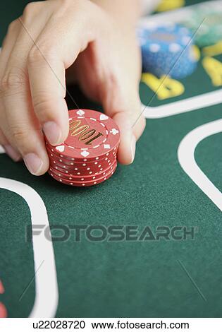 Woman with stacks of gambling chips placing bet, close-up View Large Photo Image Stock Image - Woman with stacks of gambling chips placing bet, close-up. Fotosearch