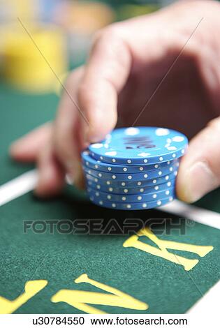 Woman with stacks of gambling chips placing bet, close-up View Large Photo Image Stock Image - Woman with stacks of gambling chips placing bet, close-up. Fotosearch