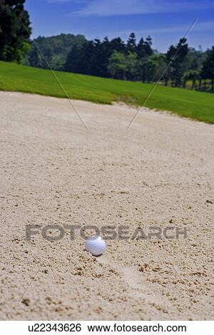 Stock Photograph - Golf ball on bunker. Fotosearch