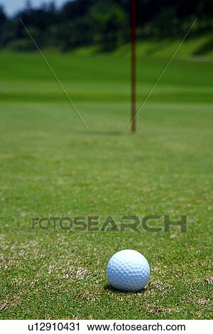 Stock Image - Golf ball on green. Fotosearch