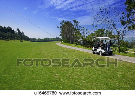 Golf cart on single lane road View Large Photo Image Stock Image - Golf cart on single lane road. Fotosearch