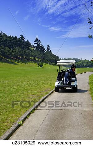 Golf cart on single lane road View Large Photo Image Stock Photo - Golf cart on single lane road. Fotosearch