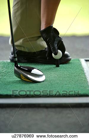 Man placing golf ball on tee View Large Photo Image Stock Photo - Man placing golf ball on tee. Fotosearch
