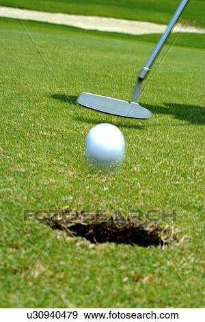 Person putting (focus on hole) View Large Photo Image Stock Photo - Person putting (focus on hole). Fotosearch