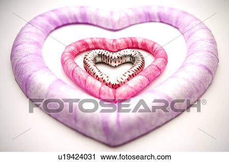 Three different sized heart shaped objects View Large Photo Image Stock Image - Three different sized heart shaped objects. Fotosearch