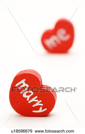 Two heart-shaped objects written "merry me" View Large Photo Image Stock Photo - Two heart-shaped objects written "merry me". Fotosearch