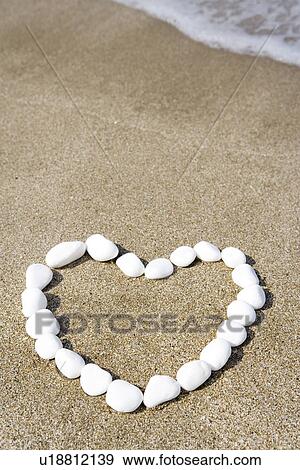 White stone form heart shape on beach View Large Photo Image Stock Photo - White stone form heart shape on beach. Fotosearch