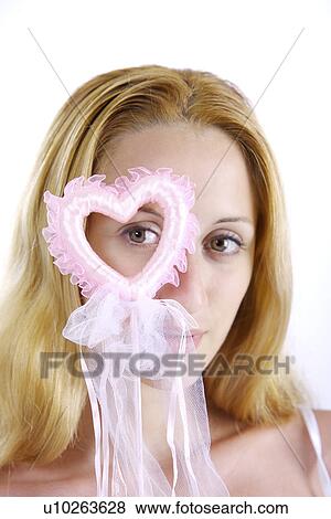 Stock Photo - Young woman holding magic wand. Fotosearch