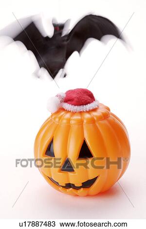 Stock Image - Bat shape and pumpkin. Fotosearch