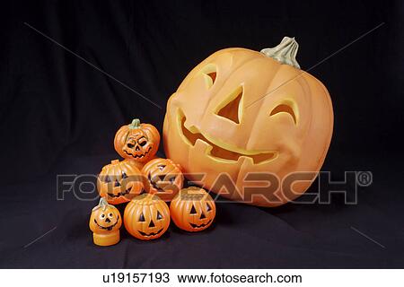 Stock Image - Pumpkins against black background. Fotosearch