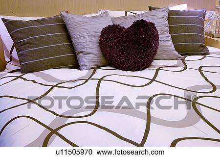 Stock Image - Bed with cushions. Fotosearch