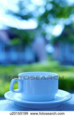Stock Photo - Coffee cup on table outdoors. Fotosearch
