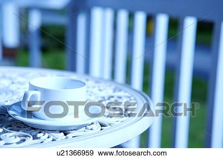 Stock Photo - Cup on table outdoors. Fotosearch
