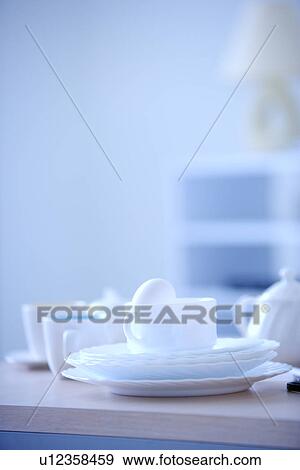 Cup, plate and kettle on table View Large Photo Image Stock Photo - Cup, plate and kettle on table. Fotosearch