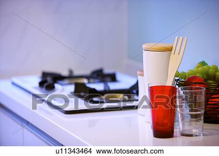 Picture - Kitchen counter with gas stove burner and food. Fotosearch