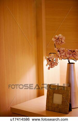 Vase and picture frame on side table View Large Photo Image Stock Photograph - Vase and picture frame on side table. Fotosearch