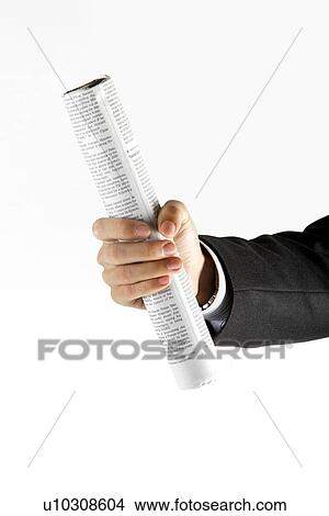 Picture - Man holding roll made from newspaper. Fotosearch