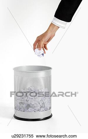 Man throwing paper in waste paper bin, close-up of hand View Large Photo Image Stock Photography - Man throwing paper in waste paper bin, close-up of hand. Fotosearch