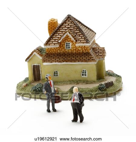 Stock Image - Two figurines and house. Fotosearch