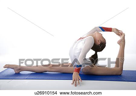 Girl practicing gymnastic pose on pad, side view View Large Photo Image Picture - Girl practicing gymnastic pose on pad, side view. Fotosearch