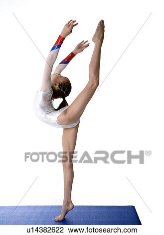 Girl practicing gymnastic pose on pad, side view View Large Photo Image Stock Image - Girl practicing gymnastic pose on pad, side view. Fotosearch