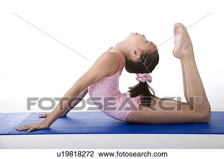 Girl practicing gymnastic pose on pad, side view View Large Photo Image Stock Image - Girl practicing gymnastic pose on pad, side view. Fotosearch