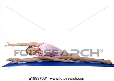 Girl practicing gymnastic pose on pad View Large Photo Image Stock Image - Girl practicing gymnastic pose on pad. Fotosearch