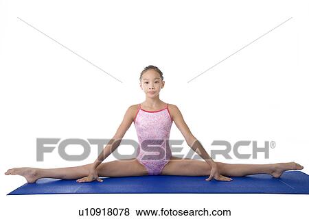 Girl practicing gymnastic pose on pad View Large Photo Image Stock Photo - Girl practicing gymnastic pose on pad. Fotosearch