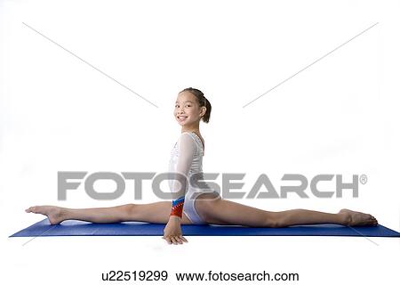 Girl practicing gymnastic pose on pad, side view View Large Photo Image Stock Photo - Girl practicing gymnastic pose on pad, side view. Fotosearch