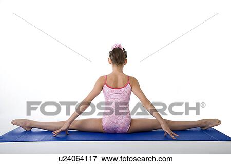 Girl practicing gymnastic pose on pad, rear view View Large Photo Image Stock Photo - Girl practicing gymnastic pose on pad, rear view. Fotosearch