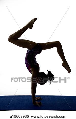 Girl practicing gymnastic pose on pad, silhouette View Large Photo Image Stock Photography - Girl practicing gymnastic pose on pad, silhouette. Fotosearch