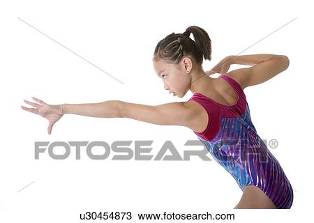 Girl practicing gymnastic pose, side view View Large Photo Image Stock Image - Girl practicing gymnastic pose, side view. Fotosearch