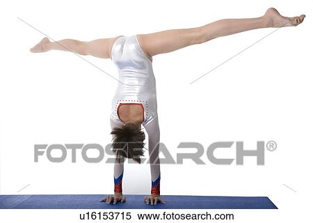 Stock Photography - Portrait of young girl doing handstand, Panoramic. Fotosearch