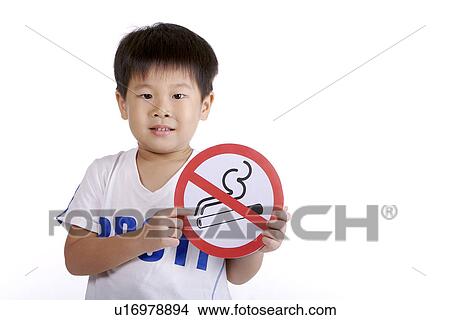 Boy holding ' No smoking sign' View Large Photo Image Picture - Boy holding ' No smoking sign'. Fotosearch