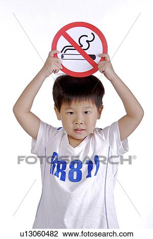 Boy holding ' No smoking sign' View Large Photo Image Stock Image - Boy holding ' No smoking sign'. Fotosearch