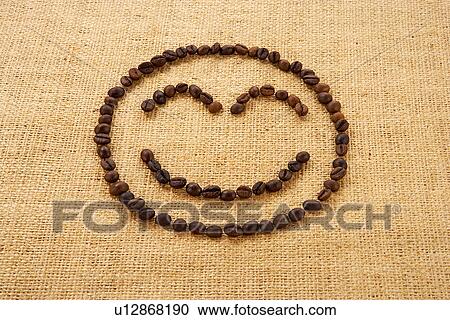 Stock Image - Coffee beans in shape of smiley face. Fotosearch