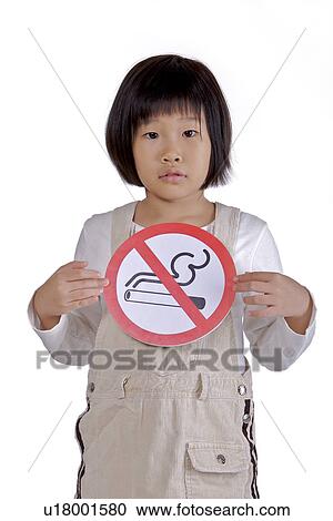 Stock Image - Girl holding 'No smoking sign'. Fotosearch