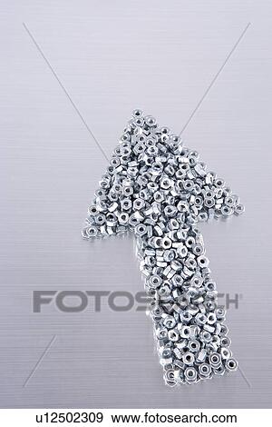 Stock Photo - Metal nuts form arrow sign. Fotosearch