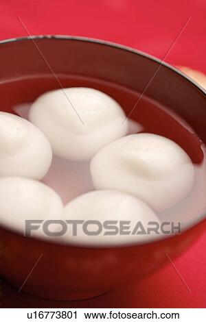 Stock Image - Bowl of dumplings, dumplings made of sweet rice, rolled into balls and stuffed with either sweet. Fotosearch