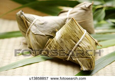 Stock Photo - Chinese Rice Dumpling, Chinese rice dumplings are a traditional Chinese food, made of glutinous rice stuffed with different fillings and wrapped in bamboo leaves. Fotosearch