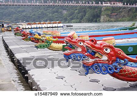 Stock Photo - Dragon boats moored at waterside. Fotosearch