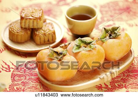 Persimmons and mooncakes View Large Photo Image Stock Image - Persimmons and mooncakes. Fotosearch