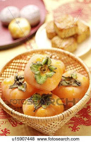 Stock Photo - Persimmons and mooncakes. Fotosearch