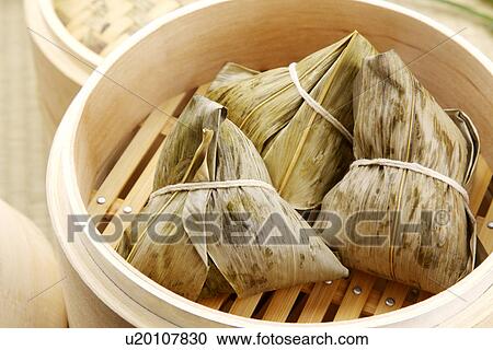 Stock Image - Steamer with chinese rice dumplings. Fotosearch