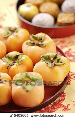 Stock Photography - Tray with Persimmons. Fotosearch