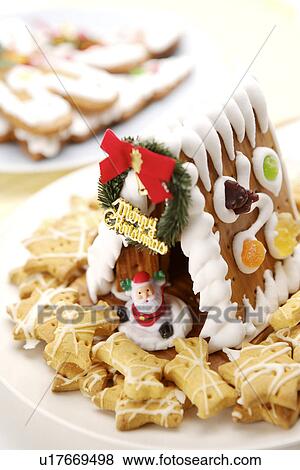 Stock Photo - Gingerbread house, cookies and Santa Claus. Fotosearch
